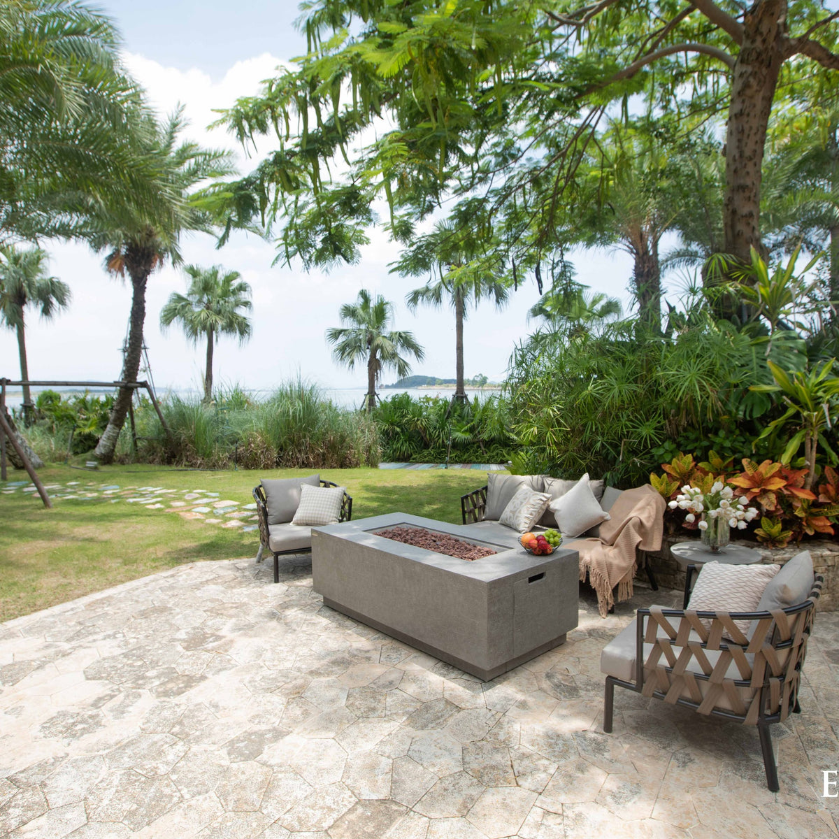 Elementi Andes Fire Table Light Gray - Tropical Garden Setting with Palm Trees and Outdoor Lounge