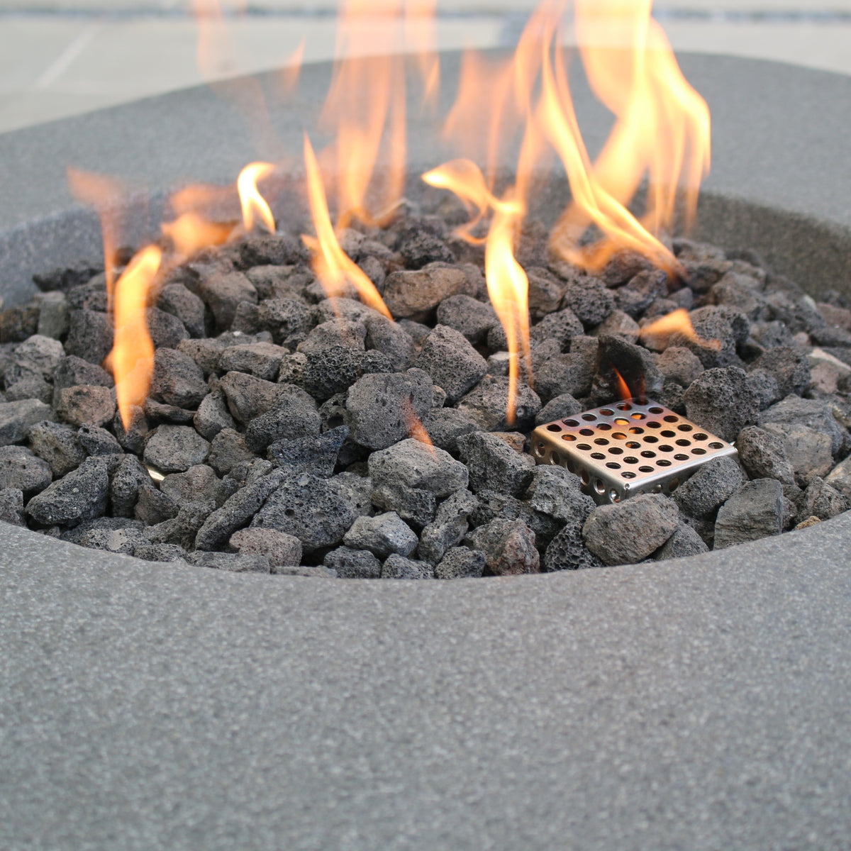 Elementi Boulder Fire Pit - Close-Up Detail of Heavy Gauge Stainless Steel Burner and Volcanic Lava Rocks