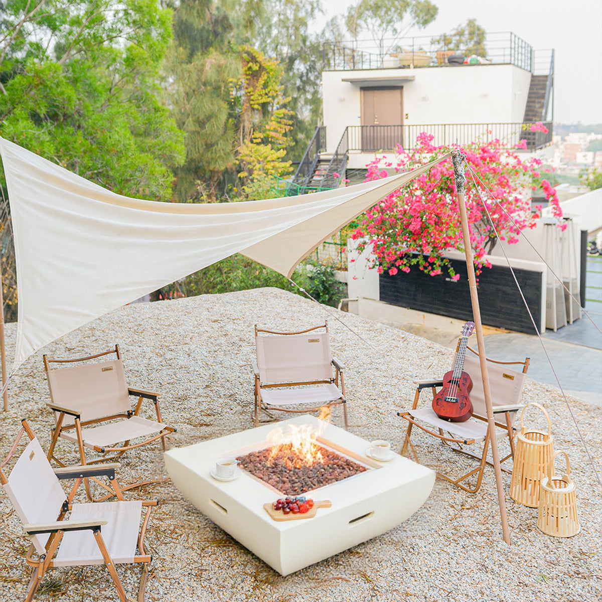 Modeno Florence Fire Table Cream White - Garden Glamping Scene under Sun Shade Sail with Lounge Chairs