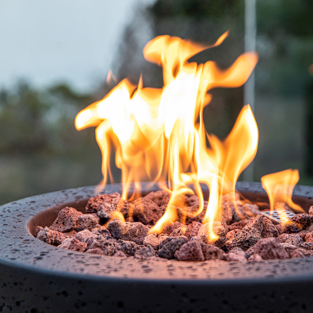 Modeno Lava Tube Propane Fire Pit - Close-Up of Roaring Flames on Lava Stones - Elementi Fires