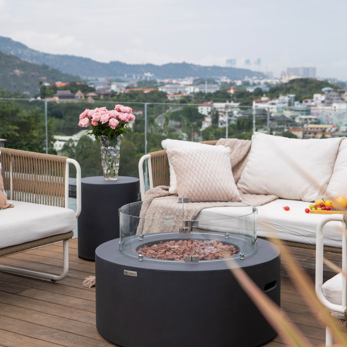 Modeno Venice Fire Table - Curved Tempered Glass Windscreen with Active Fire on Oceanfront Patio